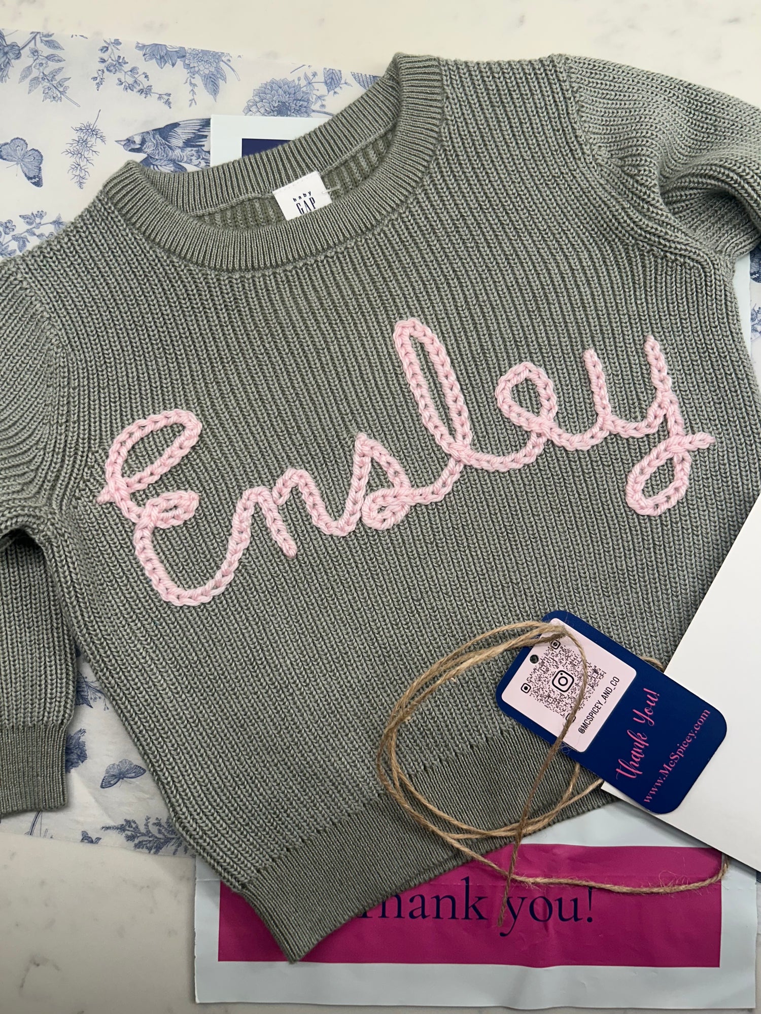 Sage Green Knit Crewneck embroidered with baby name in pink yarn. Personalized baby keepsake gift by McSpicey